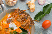 Tom Yum Kung shrimp soup and herb ingredient Thai food with decoration around.