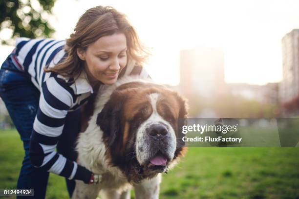 young woman hugging her dog - big hug stock pictures, royalty-free photos & images