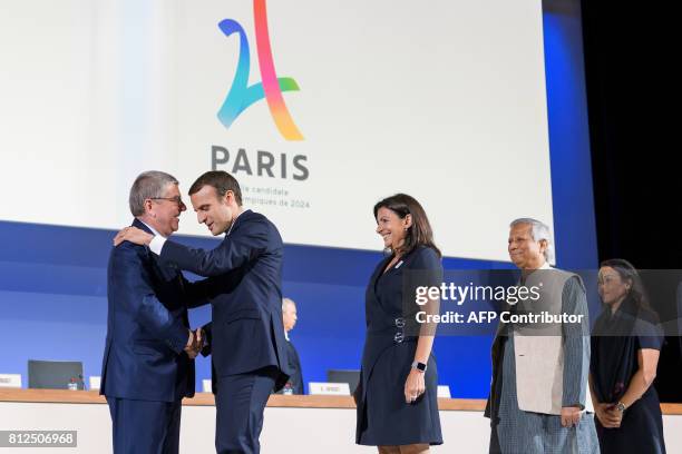 International Olympic Committee President Germany's Thomas Bach greets French President Emmanuel Macron, Mayor of Paris Anne Hidalgo, Bangladeshi...