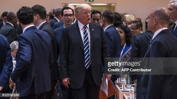 President Donald Trump arrives for the start of the first working session of the G20 meeting in Hamburg, northern Germany, on July 7, 2017. Leaders...
