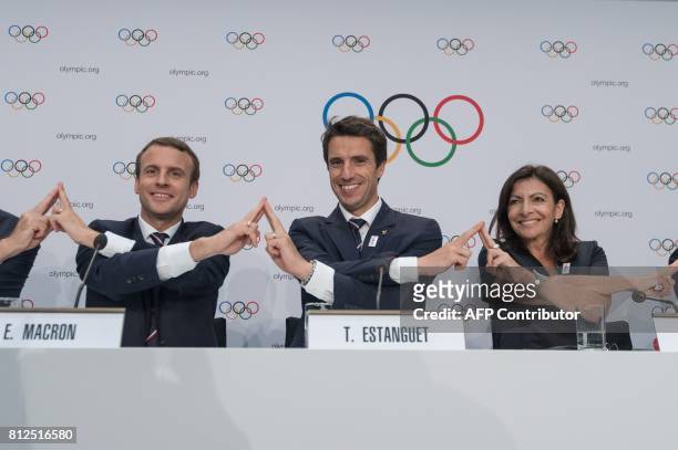 French President Emmanuel Macron poses with Paris 2024 Olympic bid co-president Tony Estanguet and Mayor of Paris Anne Hidalgo, after the Paris 2014...