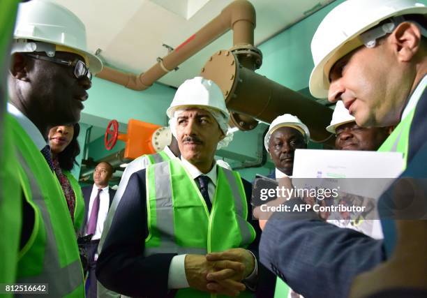 President of the Islamic Development Bank , Bandar Al Hajjar looks on as he visits a water tower in the Yopougon suburbs of Abidjan on July 11 during...