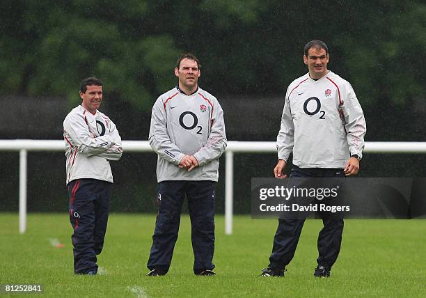 Defence Coach Mike Ford, Forwards Coach John Wells and Martin Johnson, the England Manager look on during an England training session at Bath...