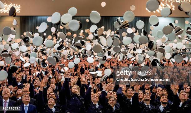 Newly-graduated police cadets in the state of North Rhine-Westphalia attend their swearingin ceremony at the Westfalenhalle on July 11, 2017 in...