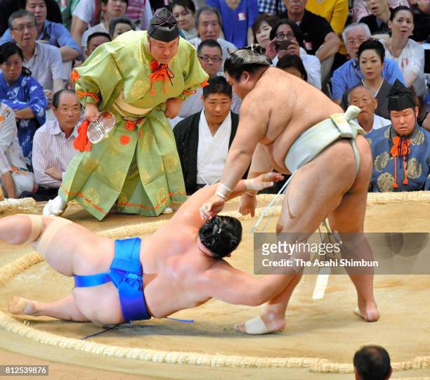 Ozeki Takayasu throws komusubi Kotoshogiku to win during day three of the Grand Sumo Nagoya Torunament at Aichi Prefecture Gymnasium on July 11, 2017...