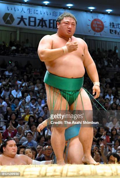 Komusubi Yoshikaze reacts after beating sekiwake Tamawashi during day two of the Grand Sumo Nagoya Torunament at Aichi Prefecture Gymnasium on July...