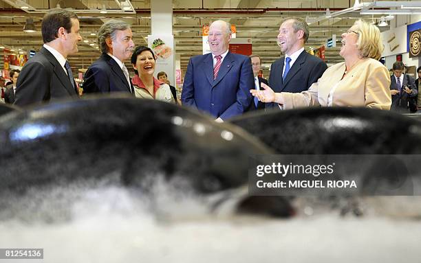 Norway's King Harald , Norwegian Fisheries Minister Helga Pedersen and Portuguese Agriculture Minister Jaime Silva joke with unidentified people on...