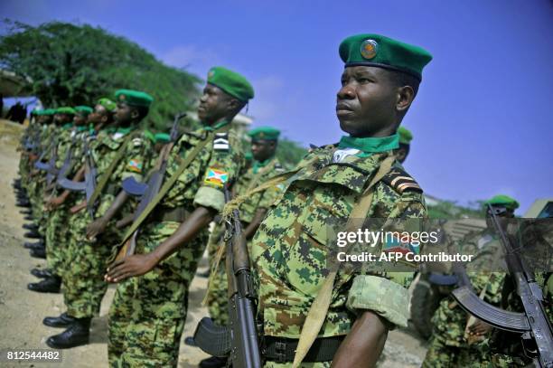 African Union soldiers from Burundi stand to attention in Mogadishu on July 11, 2017. A contingent of Burundian soldiers stationed in Somalia under...