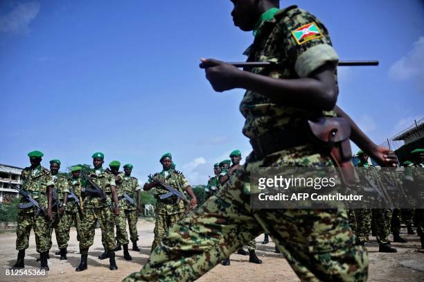African Union soldiers from Burundi stand to attention in Mogadishu on July 11, 2017. A contingent of Burundian soldiers stationed in Somalia under...