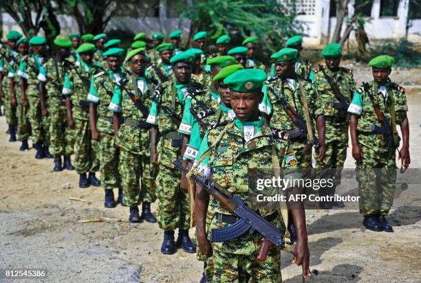 African Union soldiers from Burundi stand to attention in Mogadishu on July 11, 2017. A contingent of Burundian soldiers stationed in Somalia under...