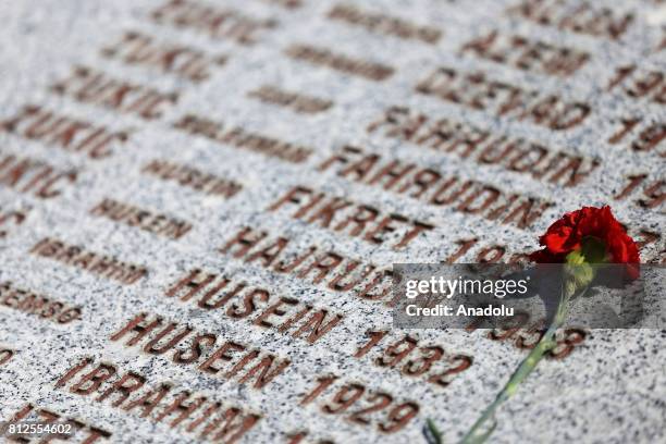 Red clove is placed on a monument containing the names of victims during a funeral ceremony of newly identified 71 Srebrenica genocide victims, to...