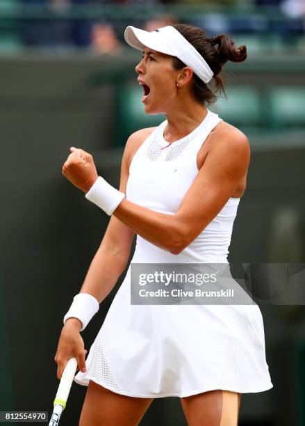 Garbine Muguruza of Spain celebrates winning the first set during the Ladies Singles quarter final match against Svetlana Kuznetsova of Russia on day...