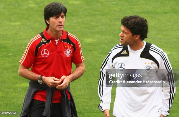 Joachim Loew , head coach of the German national football team, talks to player Michael Ballack during a Germany training session at the Son Moix...