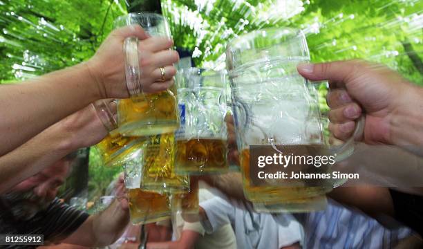 Visitors of the Augustiner beergarden cheer during a warm summer afternoon on May 28, 2008 in Munich, Germany. Visiting beergardens is very popular...