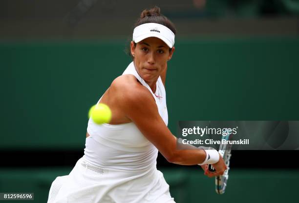 Garbine Muguruza of Spain plays a backhand during the Ladies Singles quarter final match against Svetlana Kuznetsova of Russia on day eight of the...