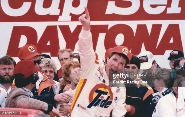 Darrell Waltrip driver of the Tide Chevrolet celebrates in victory lane after winning the Winston Cup Daytona 500 at the Daytona International...