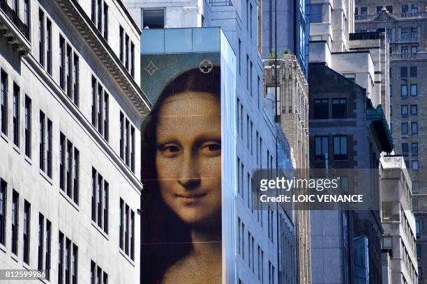 Picture shows a reproduction of Leonard Da Vinci's paint "La Joconde", on the facade of a building of Manhattan, on July 4, 2017 in New York City. /...