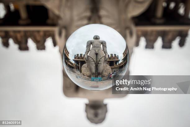 lord gommateshwara statue, shravanabelagola, india captured inside a crystal ball - digambara stock-fotos und bilder