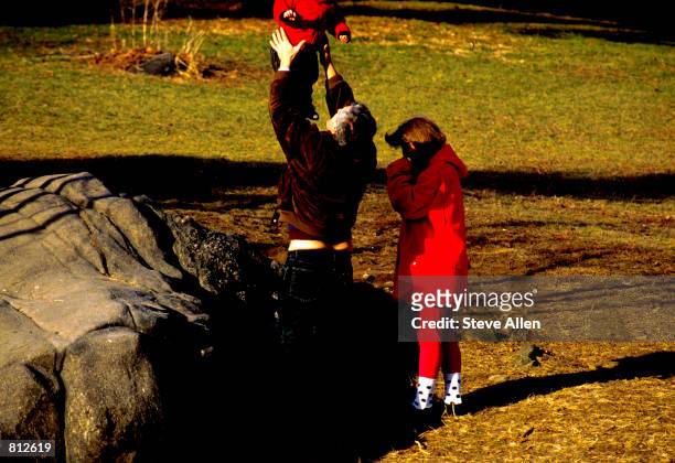 Caroline Kennedy Schlossberg and her husband, Edwin, and daughter, Rose, stoll along Central Park in New York City, January 27, 1990.