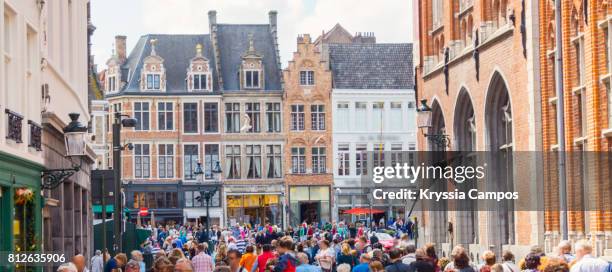 tourist and locals walking on the streets of bruges - bruge stock-fotos und bilder