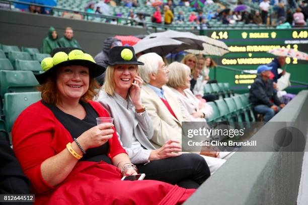 Spectators look on as rain stops play on court two during the Ladies Singles quarter final match between Magdalena Rybarikova of Slovakia and Coco...