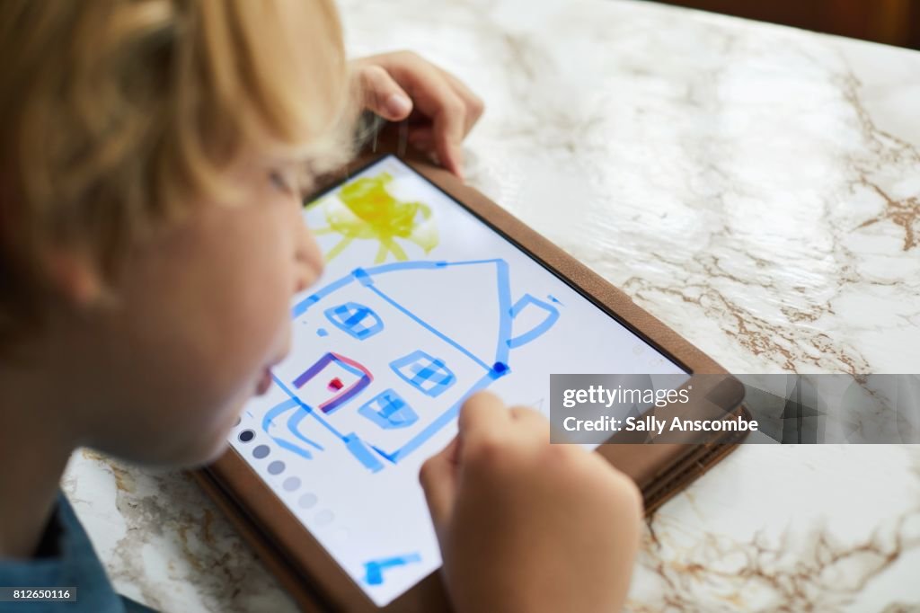 Child using a digital tablet to draw