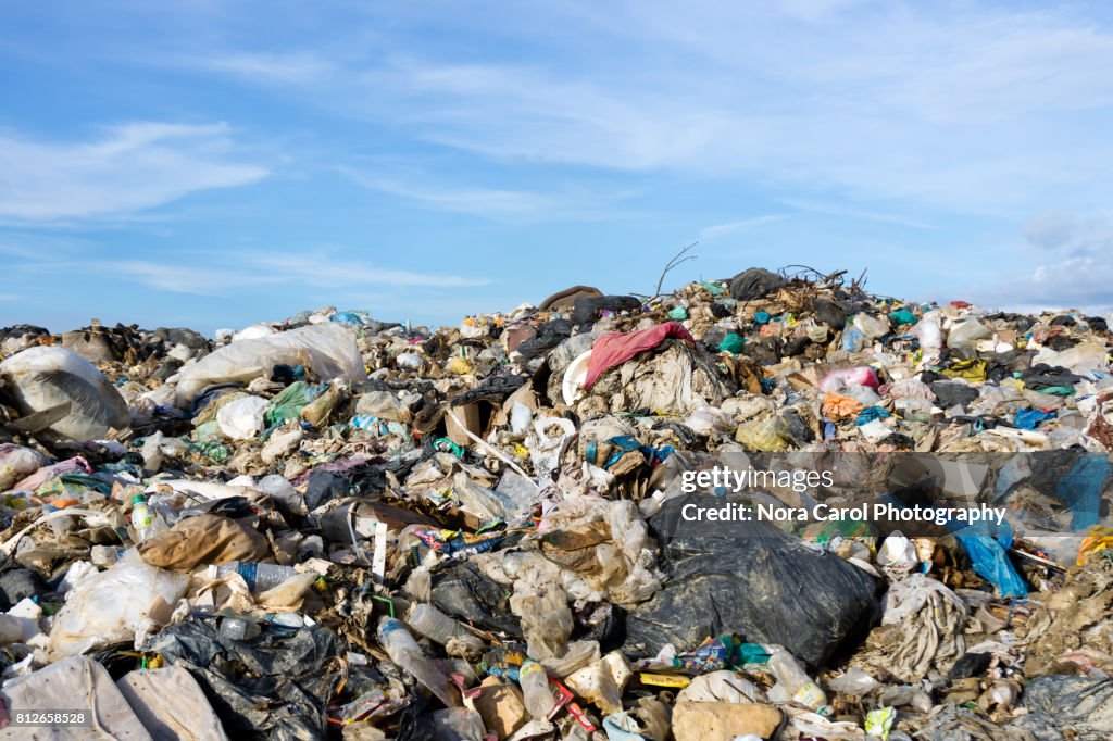 Mountain of garbage at the landfill site with blue sky
