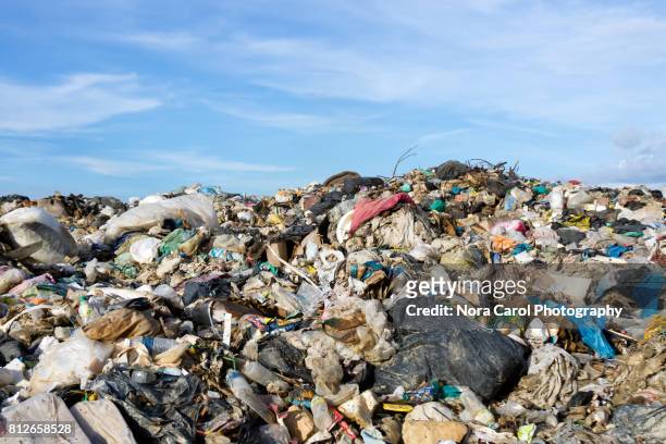 mountain of garbage at the landfill site with blue sky - garbage dump stock pictures, royalty-free photos & images