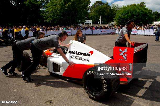 1st JULY: McLaren Honda F1 car being pushed into position in the Assembly Area at Goodwood on 1st July 2017 in Chichester, England.