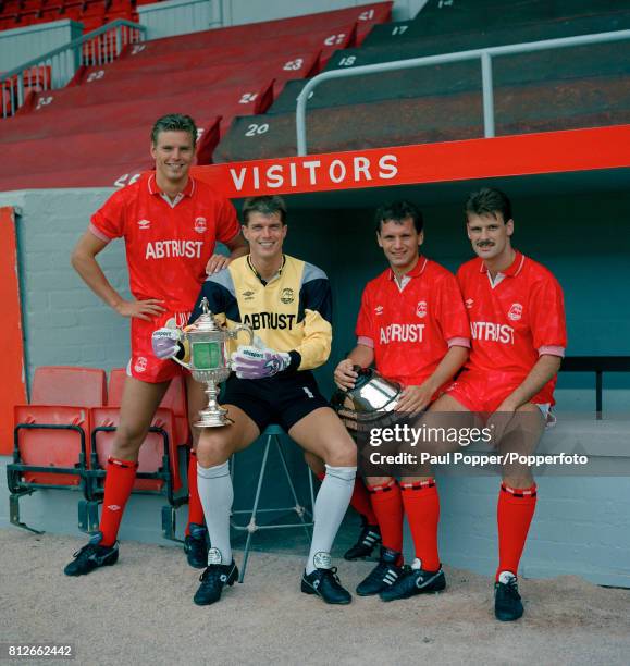 Aberdeen's Dutch footballers Willem Van Der Ark, Theo Snelders, holding the Scottish FA Cup, Hans Gillhaus, with the plinth, and Peter Van De Ven at...