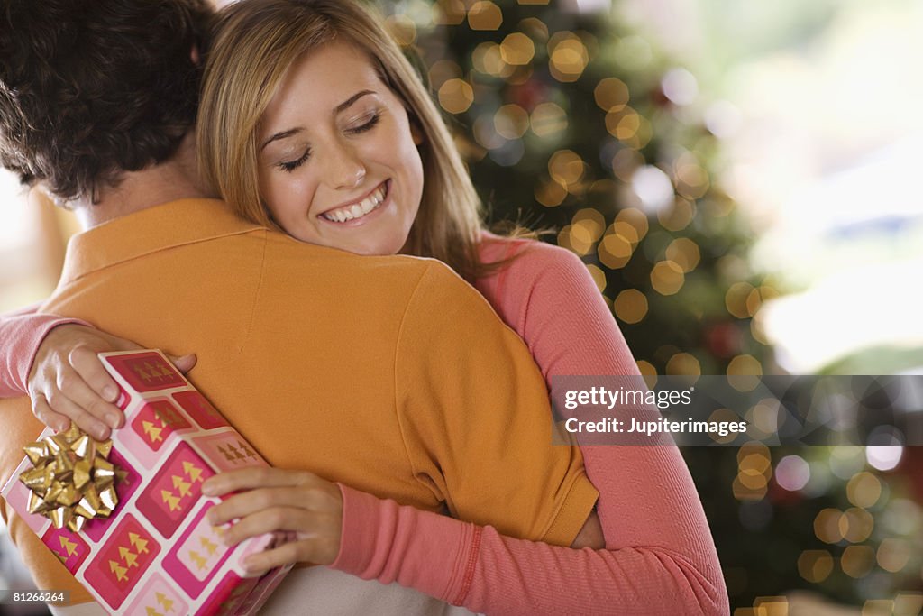 Teenagers embracing at Christmas