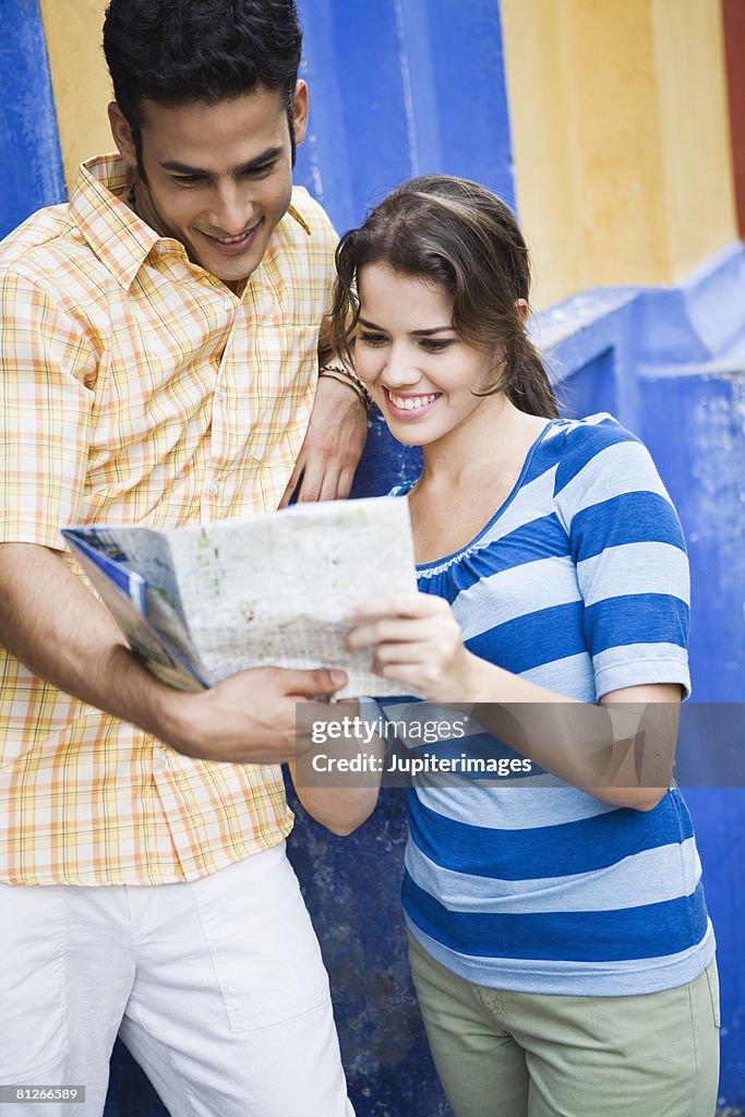 Smiling couple looking at map