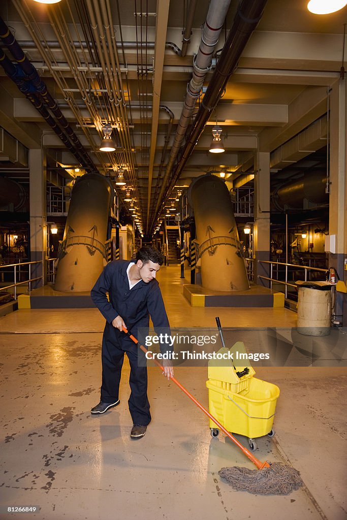 Worker mopping floor