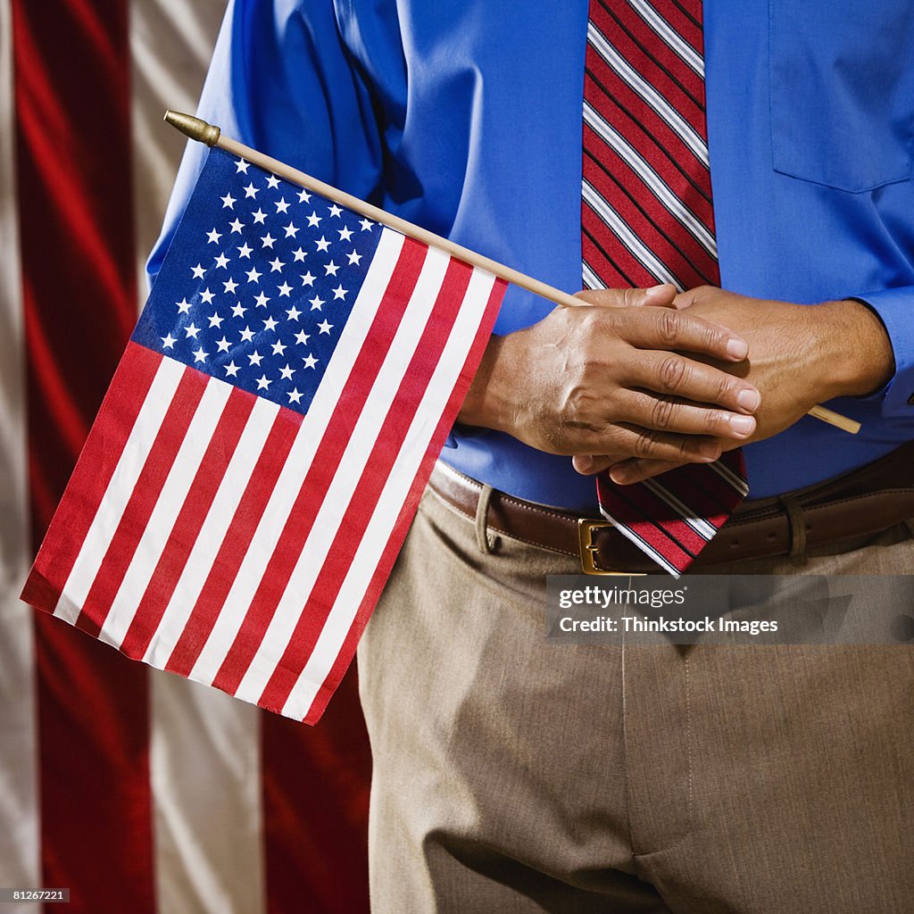 Man holding small American flag