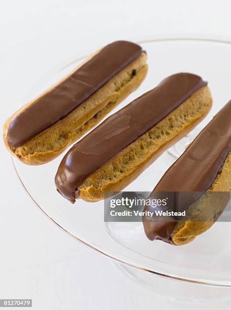 chocolate eclairs - cake stand isolated stock pictures, royalty-free photos & images