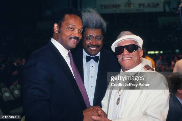 Minister And Politician Jesse Jackson with Promoter Don King and Comedian Redd Foxx at Tyson vs Holmes Convention Hall in Atlantic City, New Jersey...