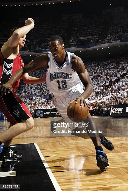 Dwight Howard of the Orlando Magic drives to the basket against Rasho Nesterovic of the Toronto Raptors in Game Two of the Eastern Conference...