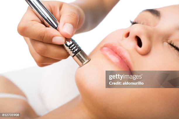 close up of woman's face on beauty treatment - microdermabrasion stock pictures, royalty-free photos & images