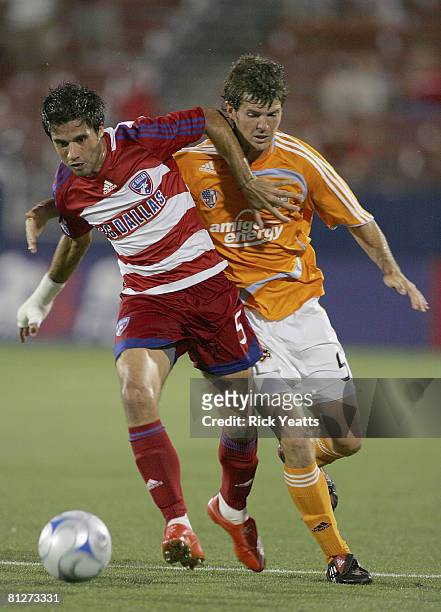 Marcelo Saragosa of FC Dallas moves the ball against Kyle Brown of the Houston Dynamo on May 24, 2008 at Pizza Hut Park in Frisco, Texas. The match...