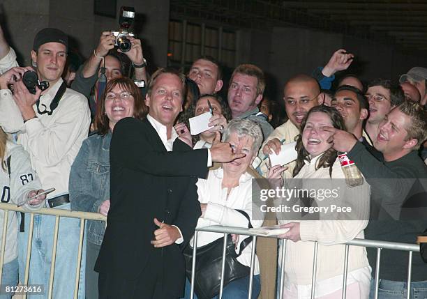 Kiefer Sutherland signing autographs and posing with fans outside the party.