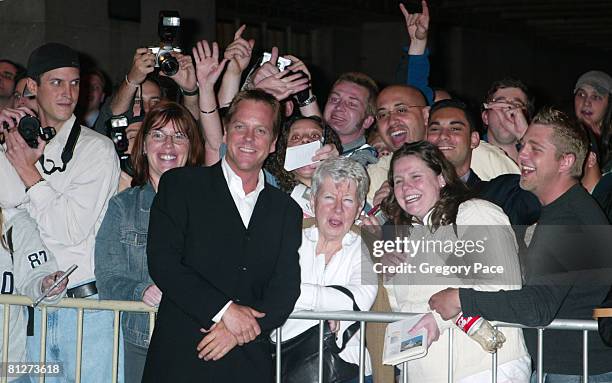 Kiefer Sutherland signing autographs and posing with fans outside the party.