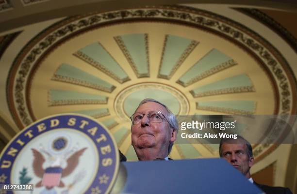 Senate Majority Leader Sen. Mitch McConnell and Sen. John Thune listen during a news briefing after the weekly Senate Republican Policy Luncheon July...