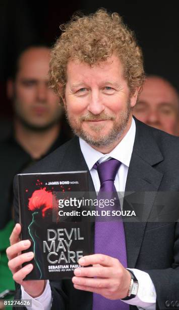 Author Sebastian Faulks takes receipt of one of the first copies of the new James Bond novel entitled 'Devil May Care' aboard HMS Exeter in London,...