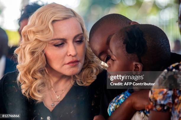 Popstar Madonna, her son David Banda and one of her newly adopted daughters attend the opening ceremony of the Mercy James Children's Hospital named...