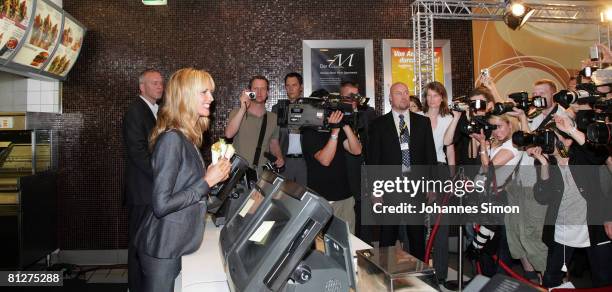 Super model Heidi Klum poses with three new designed McDonald's chicken wraps during a press conference at the Munich Inner City McDonald's...