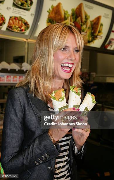 Super model Heidi Klum poses with new designed McDonald's chicken wraps during a press conference at the Munich Inner City McDonald's Restaurant 'Im...