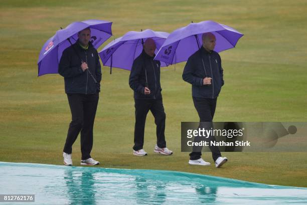 Umpires, Michael Gough, Jeff Evans and Alex Wharf inspect the pitch during the NatWest T20 Blast match against Northamptonshire Steelbacks and...