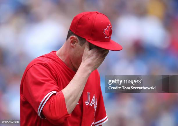 Lucas Harrell of the Toronto Blue Jays reacts as he heads to the dugout at the end of the sixth inning during MLB game action against the Houston...