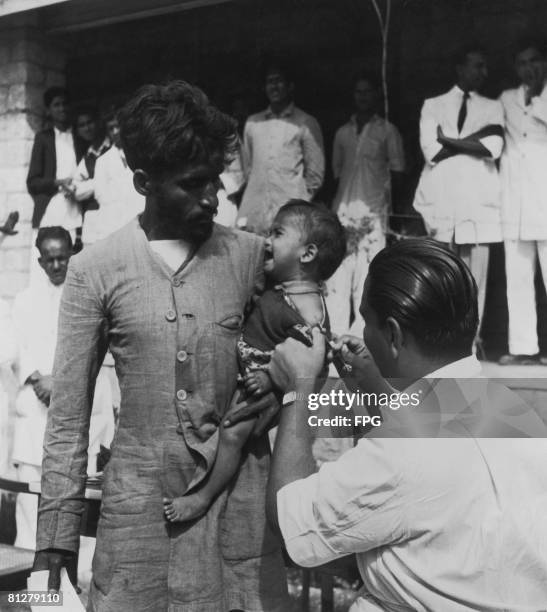 Baby girl receives her BCG vaccination against tuberculosis at a United Nations-funded clinic in Pakistan, circa 1950.