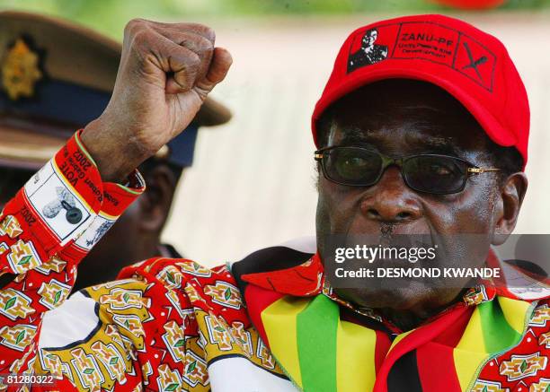 Zimbabwean President Robert Mugabe raises his fist on May 29, 2008 at a rally in Mvurwi some 100km from Harare. President Mugabe will never vacate...